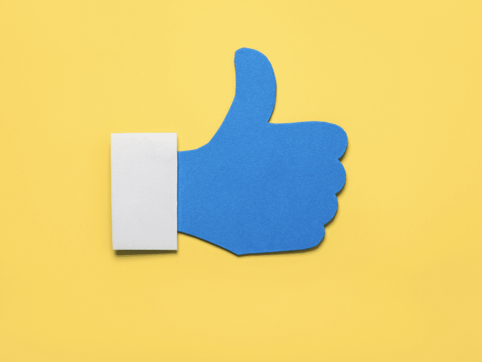 social media like icon in blue on yellow background